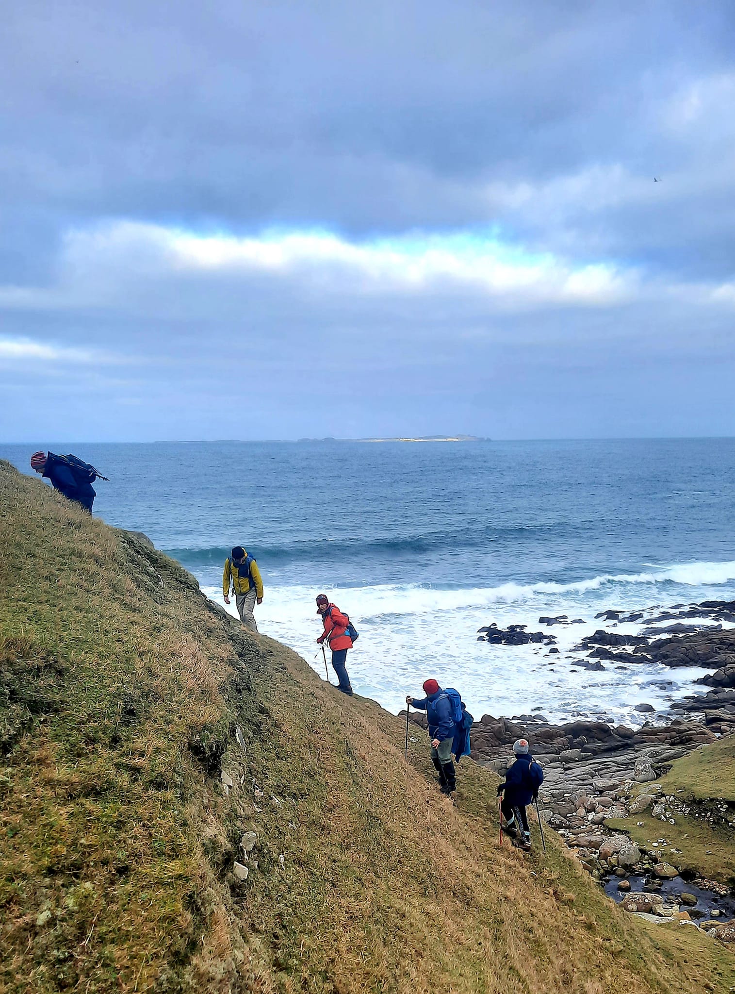 A group of hillwalkers enjoying a coastal view in County Donegal.